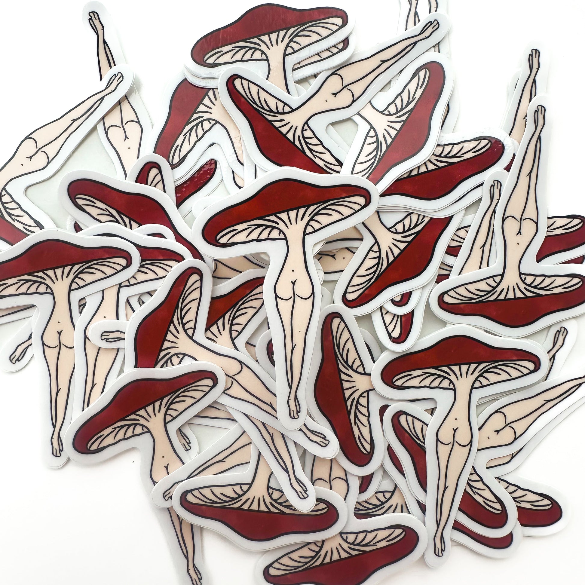 Collection of red and beige mushroom-shaped stickers on a white background