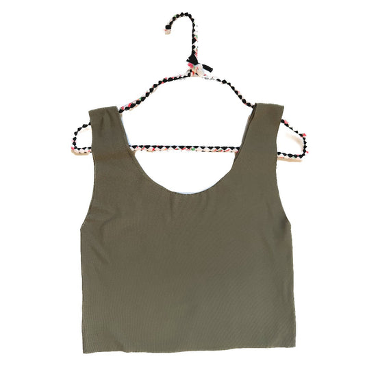 Green tank top on a hanger against a white background