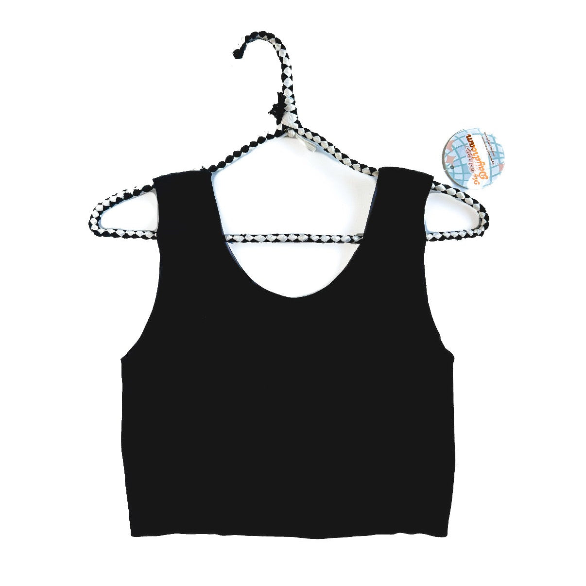 Black tank top on a hanger with a white background