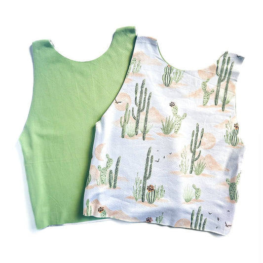 Green tank top and white tank top with cactus pattern on a white background