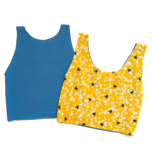 Blue tank top and yellow bees and floral tank top on a white background