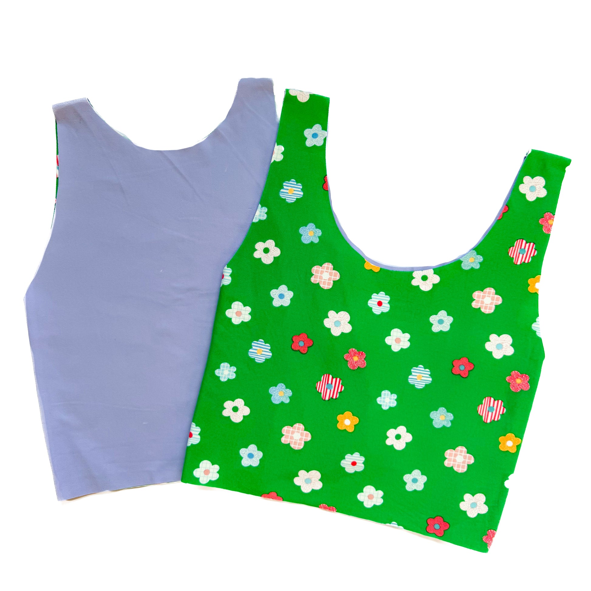 Purple tank top and green floral-patterned tank top on a white background